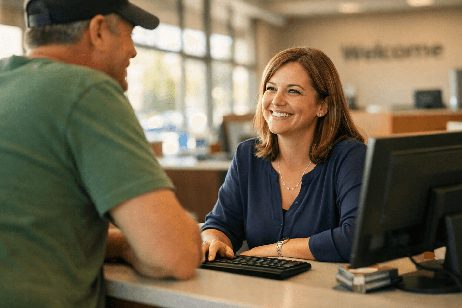 Credit union teller using CU*NorthWest CBX member service software at branch counter