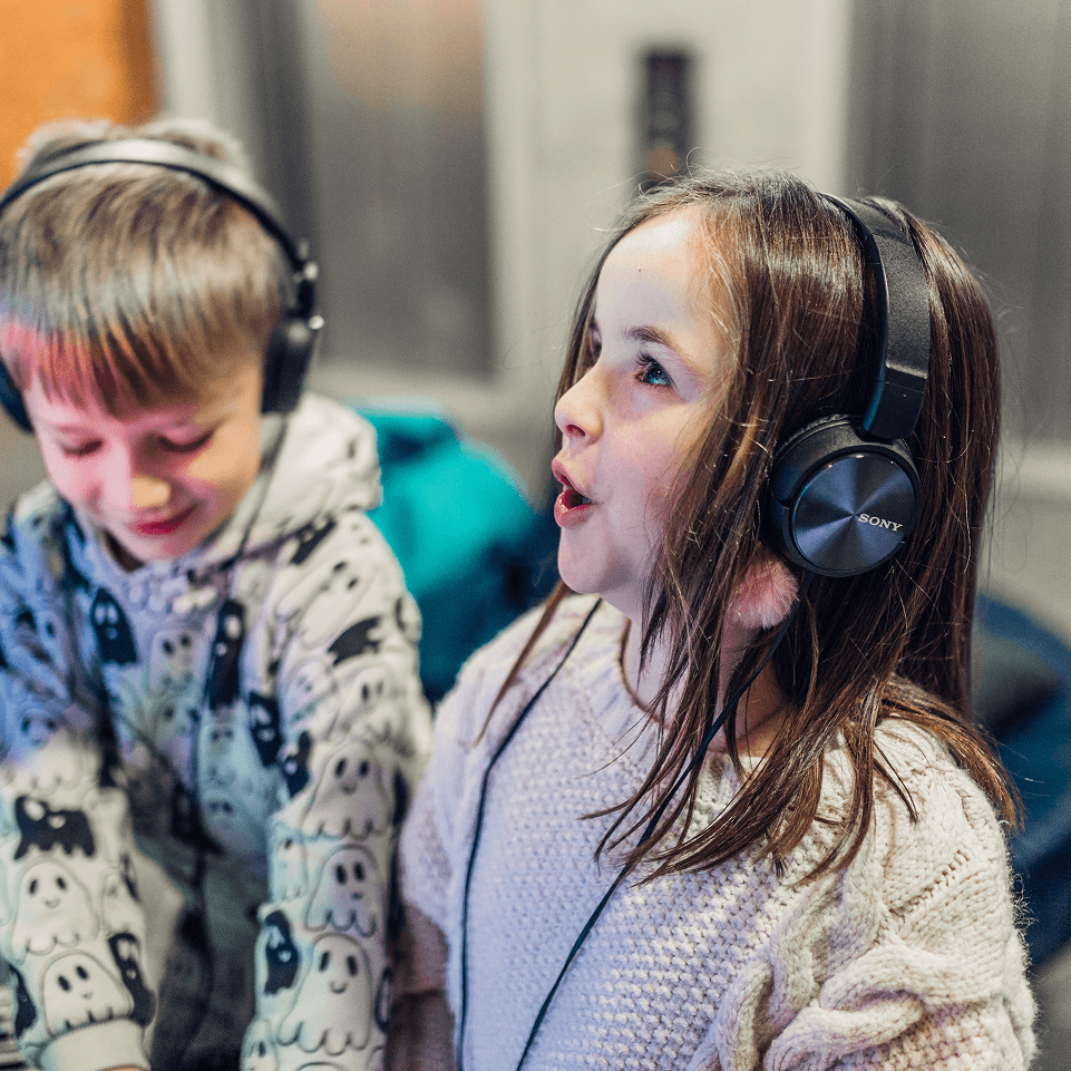 Person holding a smartphone showing the Resilico app with flood alerts and safety options.