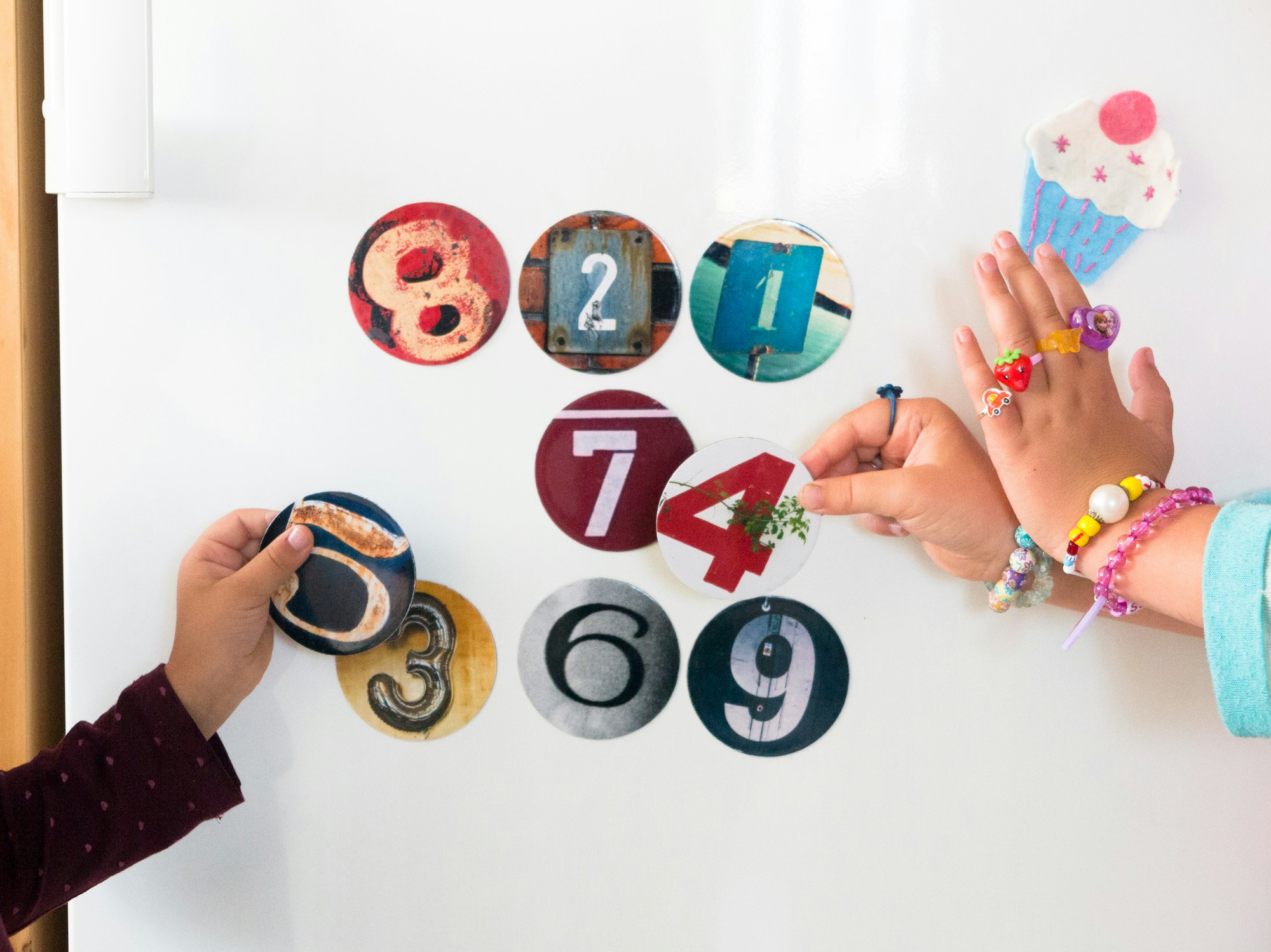 Two children completing an activity with colorful magnets