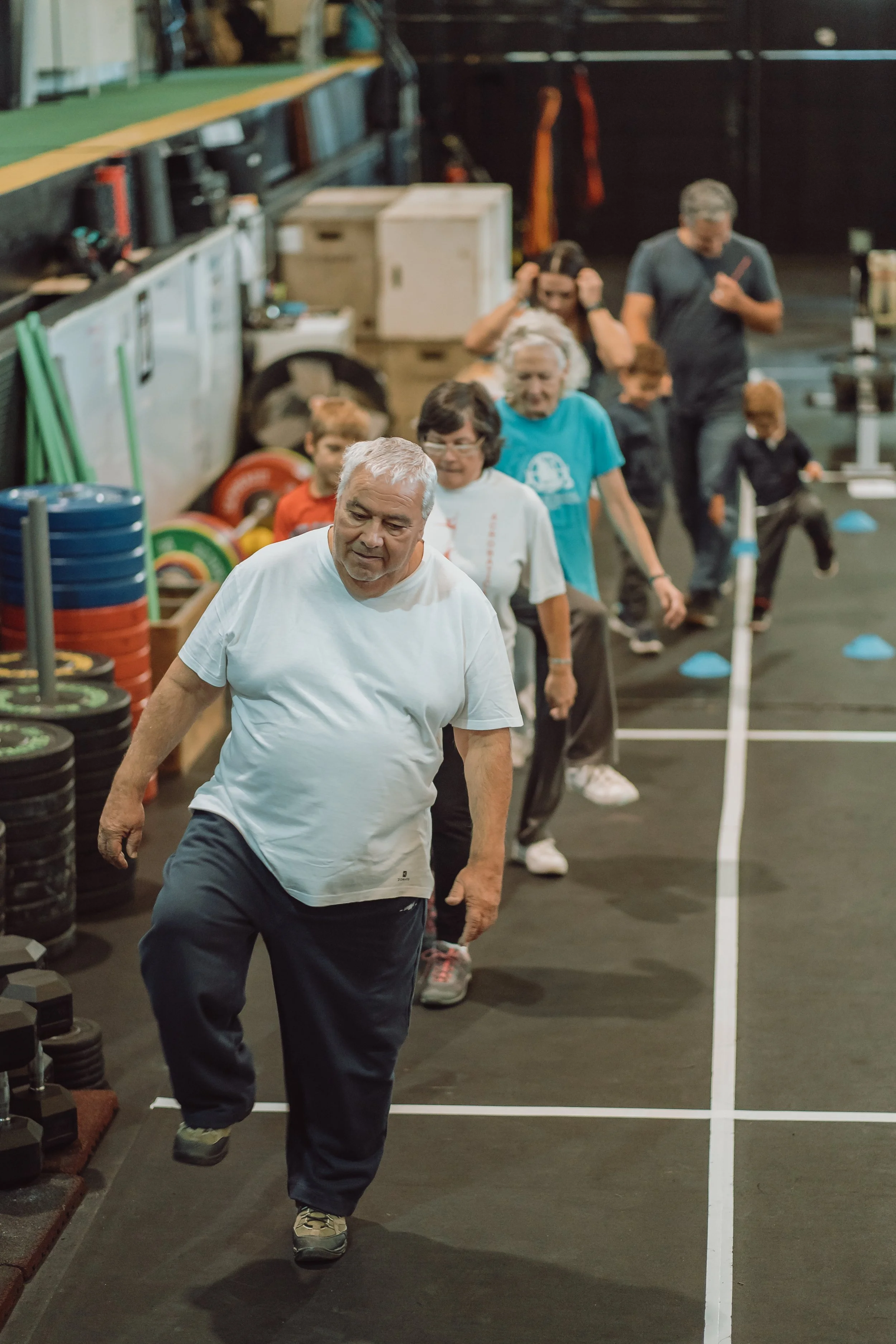 Atletlas senior em fila a fazer exercicio