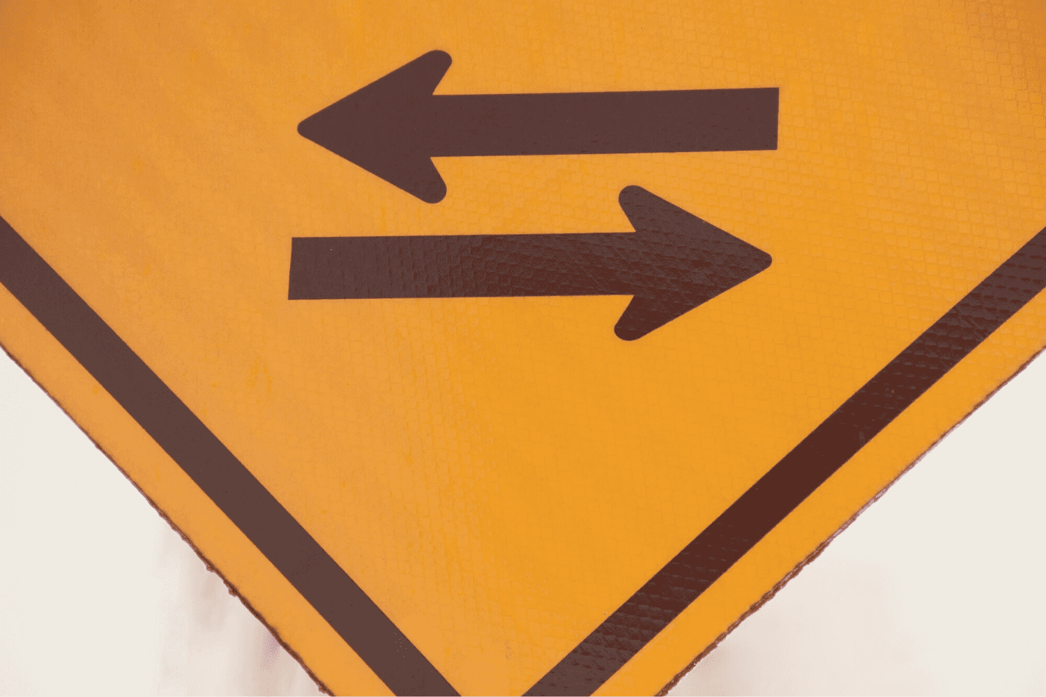 Sign showing split in the road symbolzing that small business owners must often make a decision.