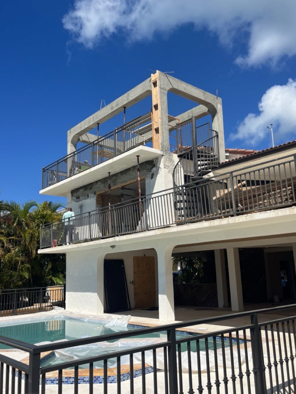 Modern living room with vertical garden, yellow sofas, and stylish coffee tables.