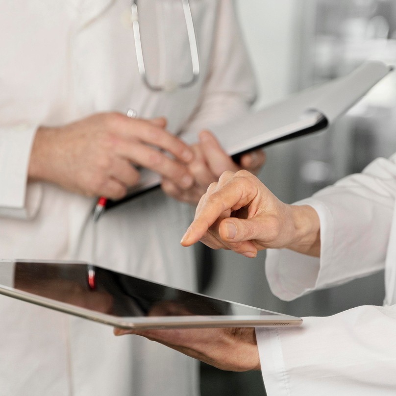 Doctor using tablet, representing AI in healthcare.