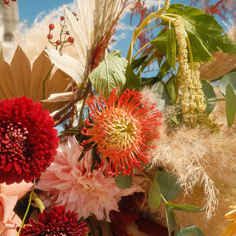 Lily flowers on outside dining table with candles