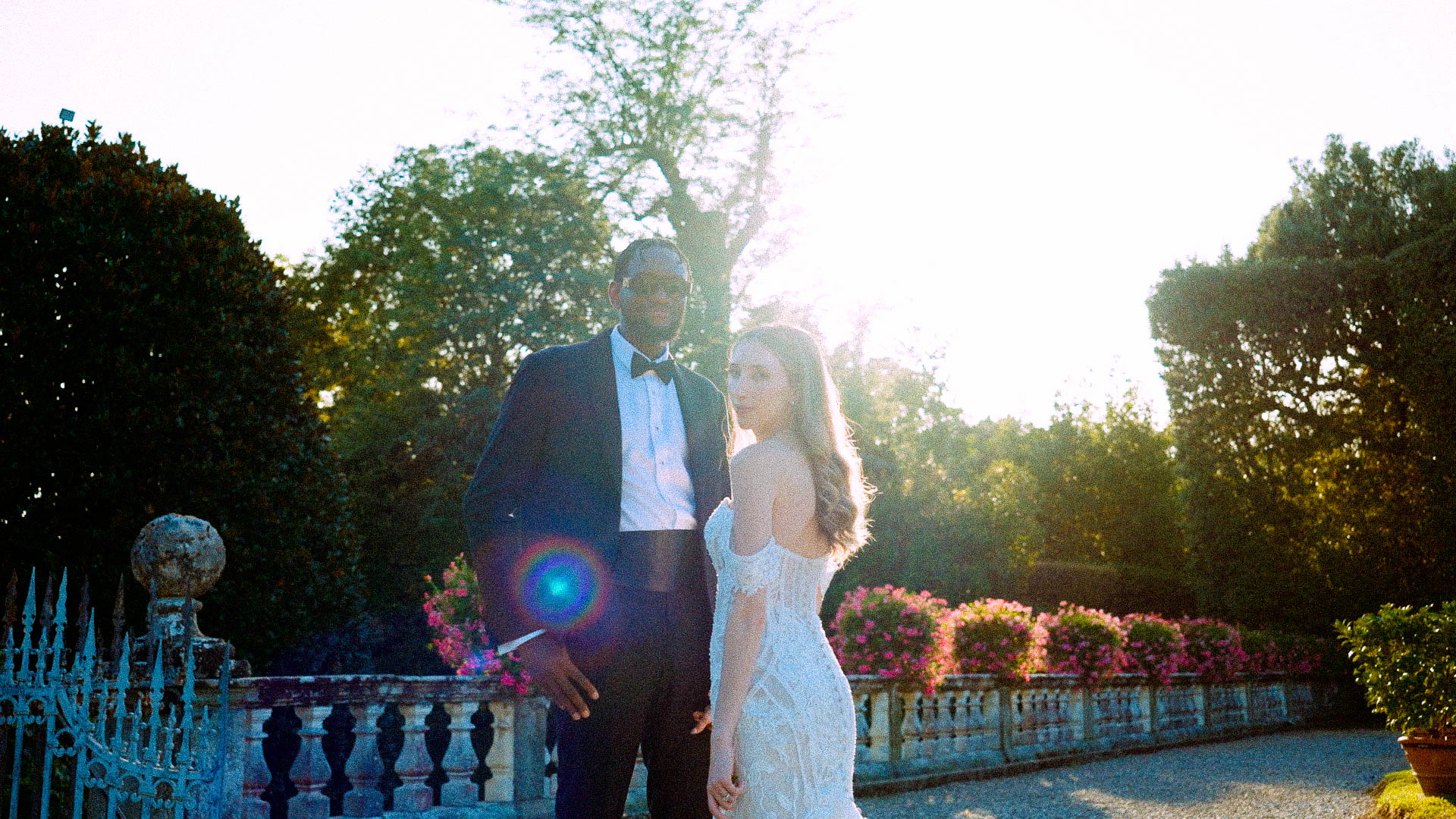 Bride and groom standing in a lush garden during a romantic destination wedding in Italy
