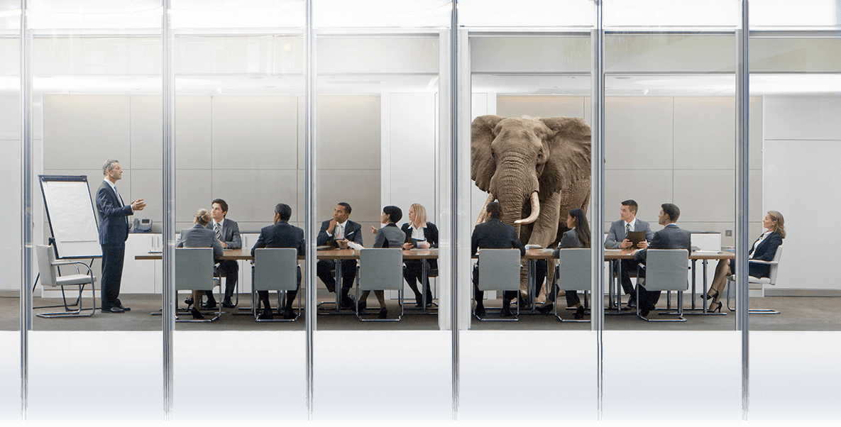 Inneffective leader speaking to a roomful of disengaged team members with a large elephant in the room