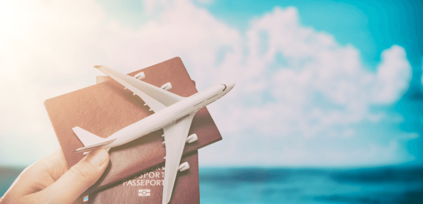 aeroplane and passport heldin hand