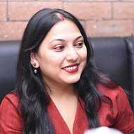 a man in a suit and tie sitting in a chair