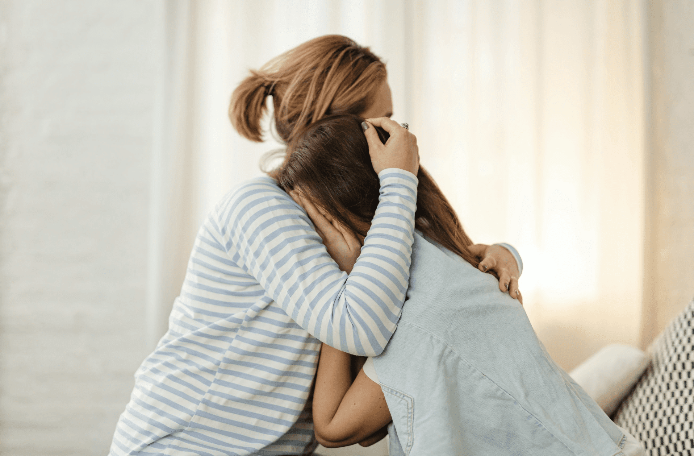 Conversion Truth for Families - 4 young women placing their hands on the back of a woman in a green top.
