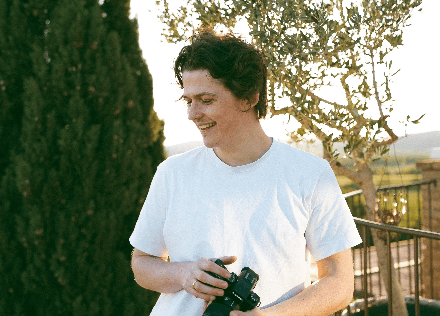 Wedding videographer holding camera at a destination wedding in Italy