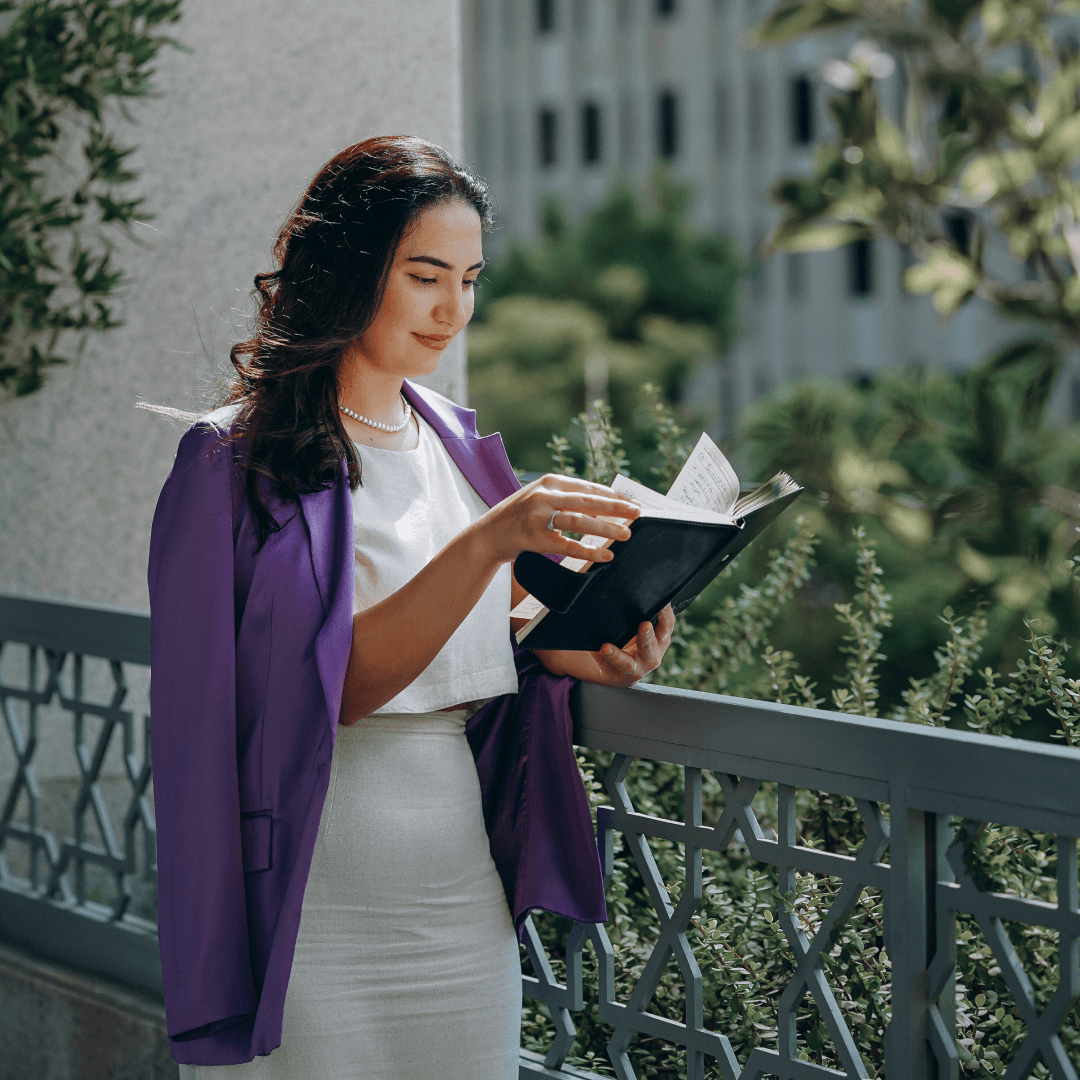 Close-up of lush, dark green leaves, some glossy and wet, against a muted background.