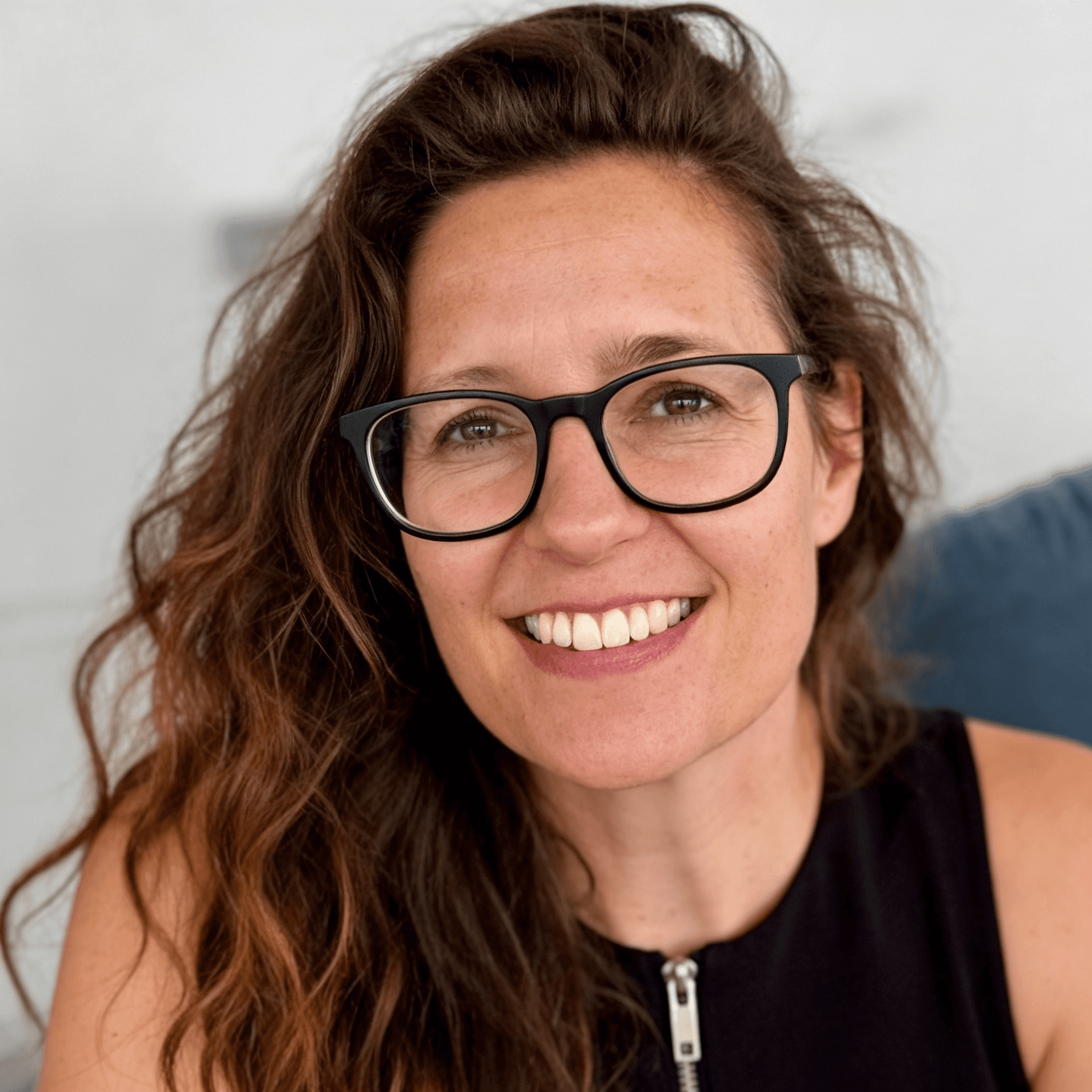 Female with glasses looking at the camera