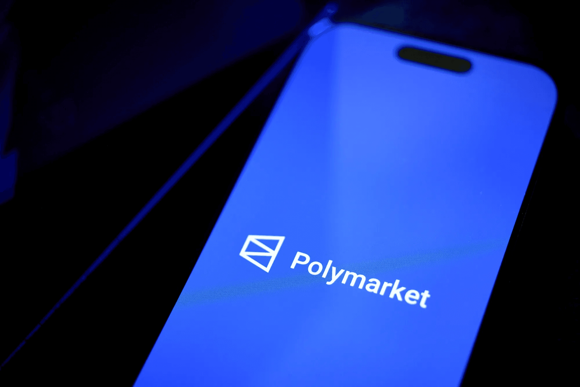 Smartphone displaying Polymarket logo - What Is Polymarket Prediction Market