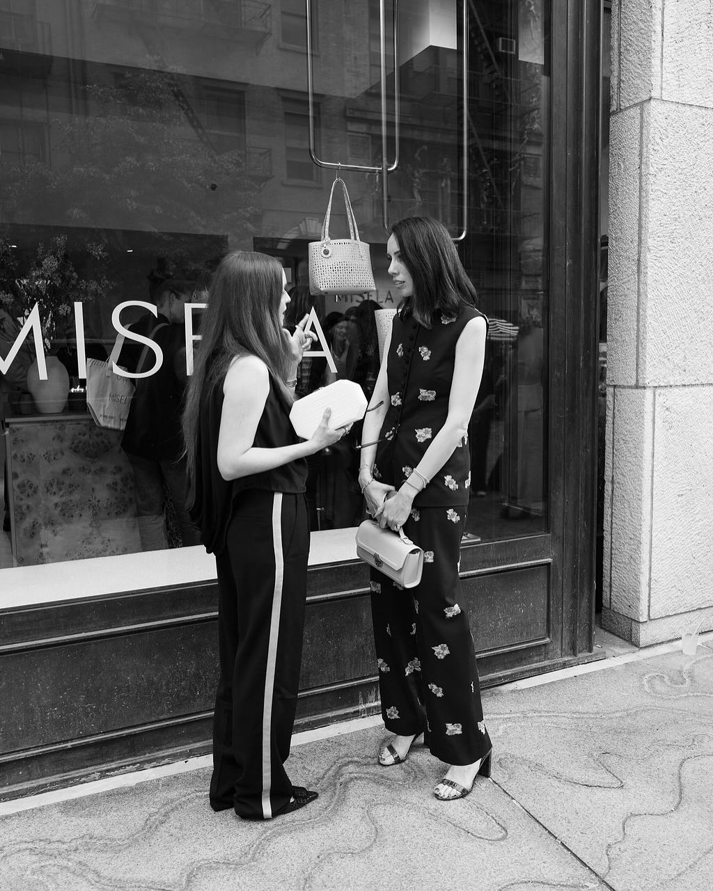 Reflected street view of Misela storefront signage on Bond Street New York during the store opening.