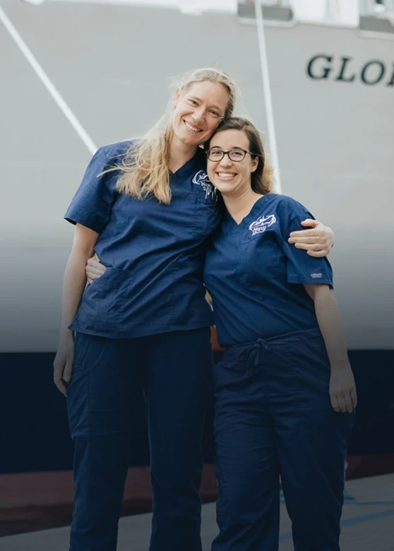 Two volunteers hugging each other