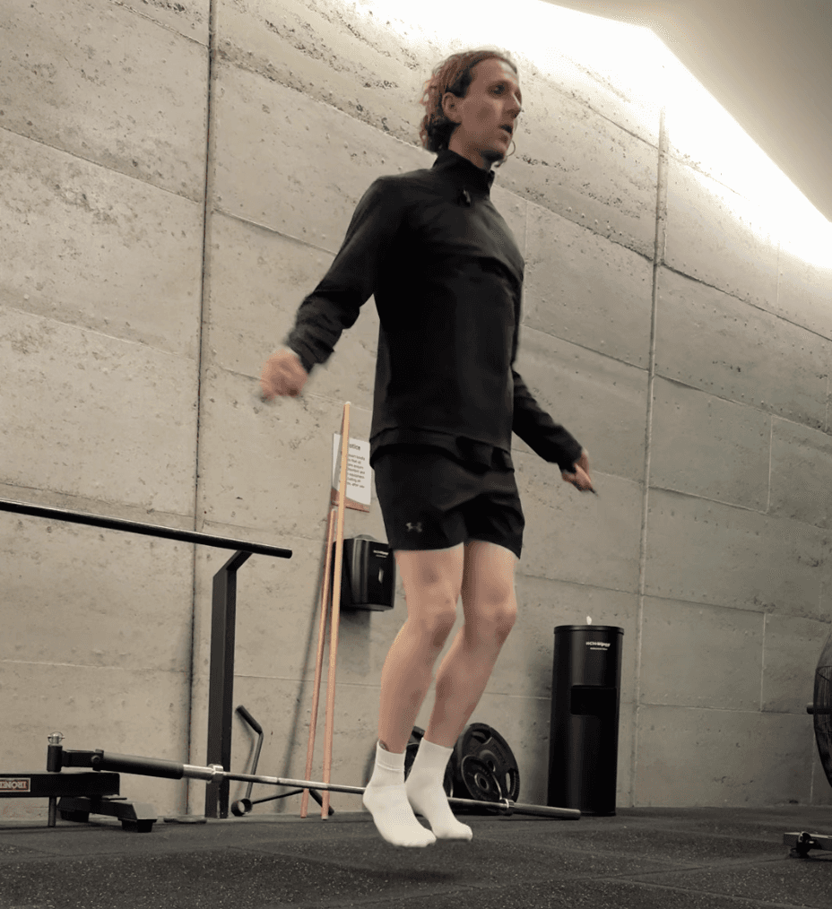 Restored brick building with arched windows and modern glass storefront on a quiet street