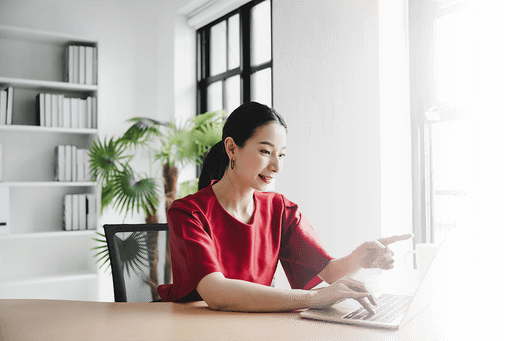 A woman points at a computer screen