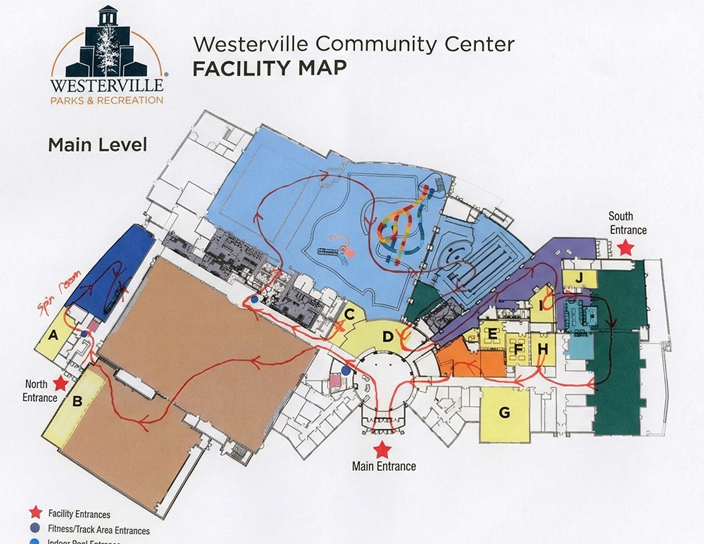 Modern bathroom featuring wooden cabinetry, a bathtub, a sleek sink, and natural light from a window.