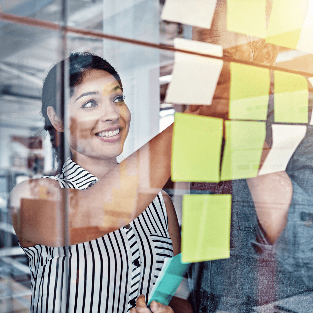 Image of female professional organising post-it notes