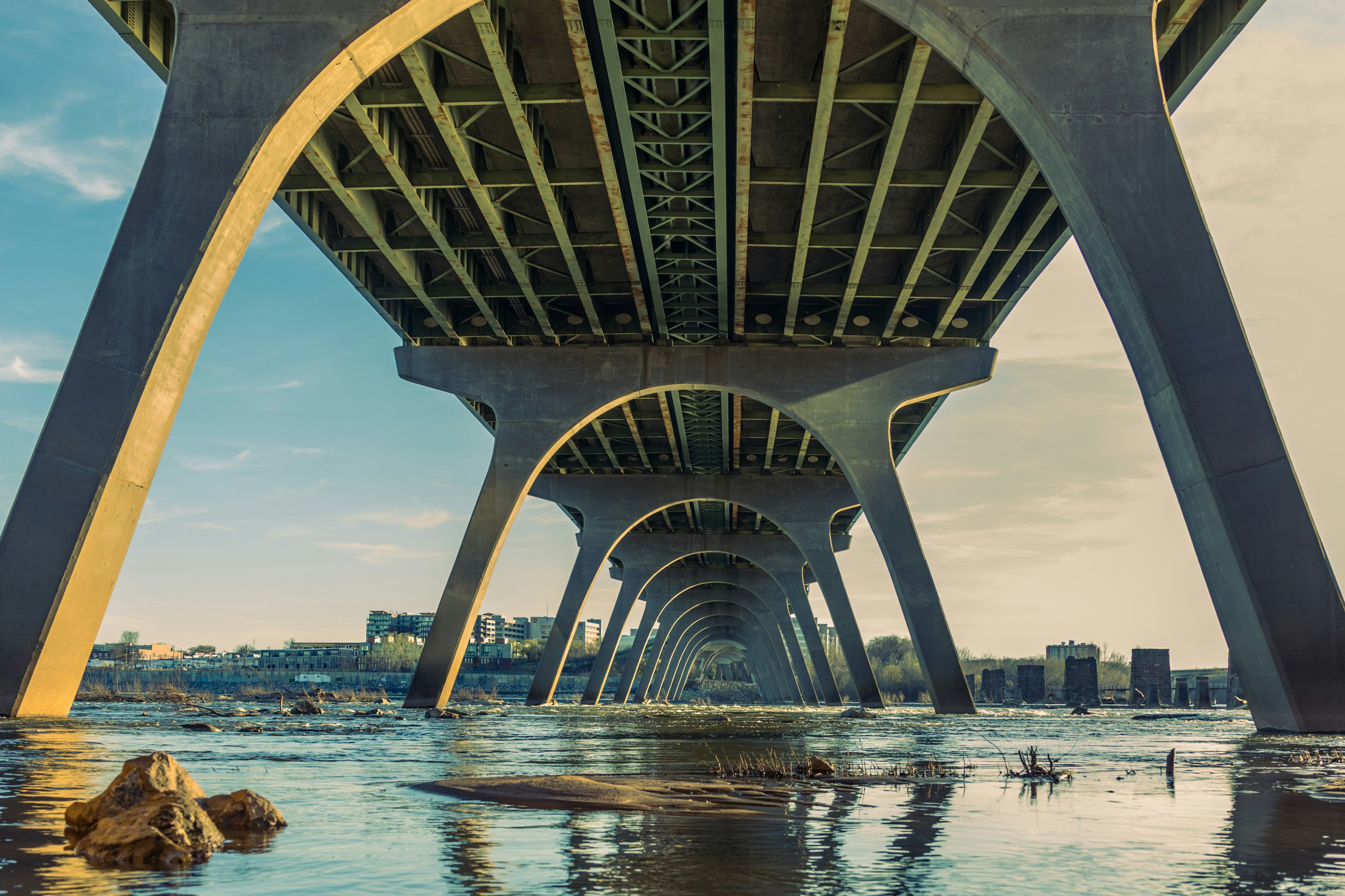 gray concrete bridge over body of water during daytime