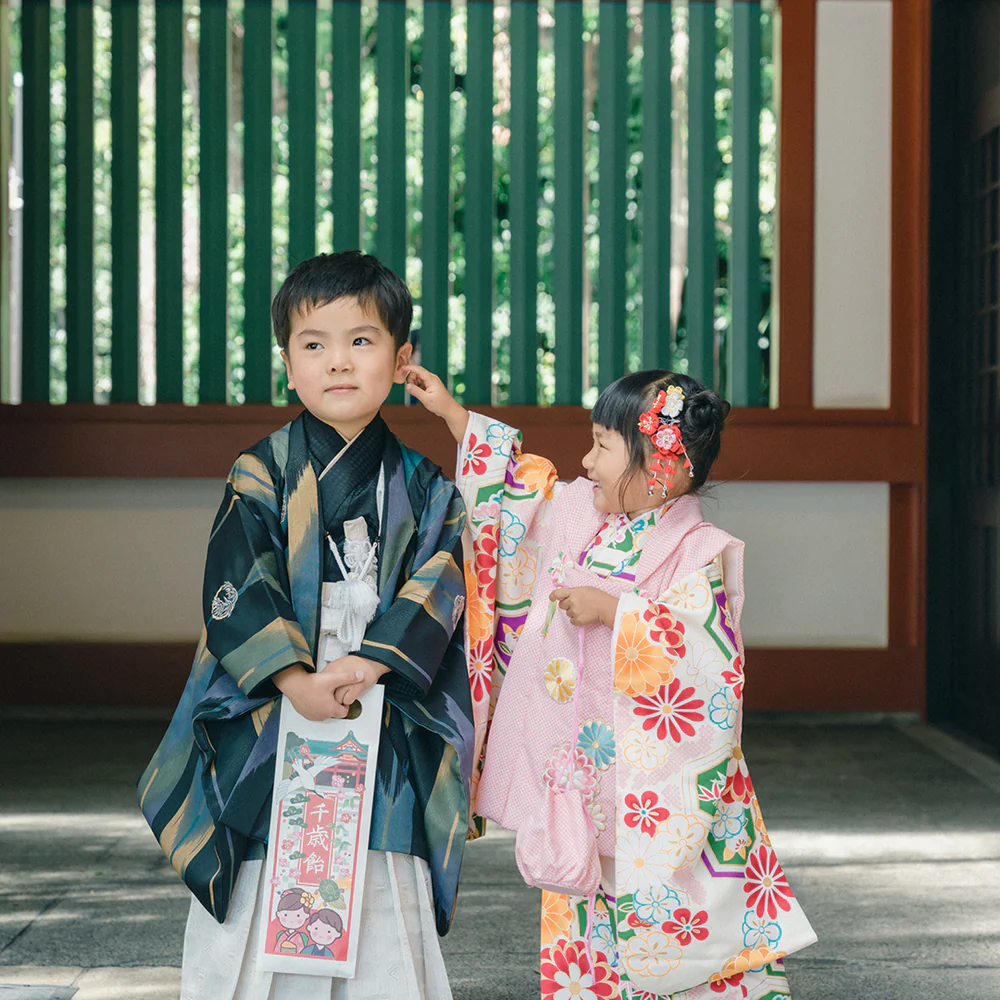 Minimalist abstract image of a stylized turquoise hand gesture on a dark background