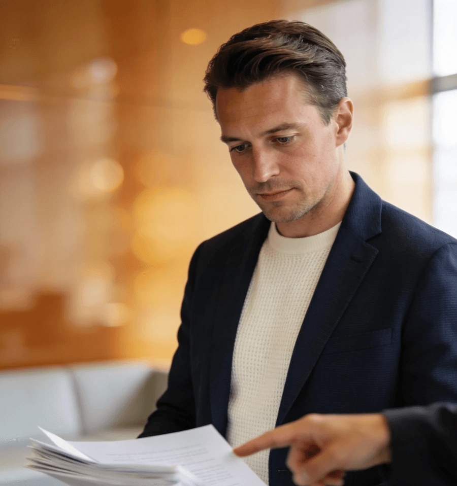 A man in a dark blazer in an office environment