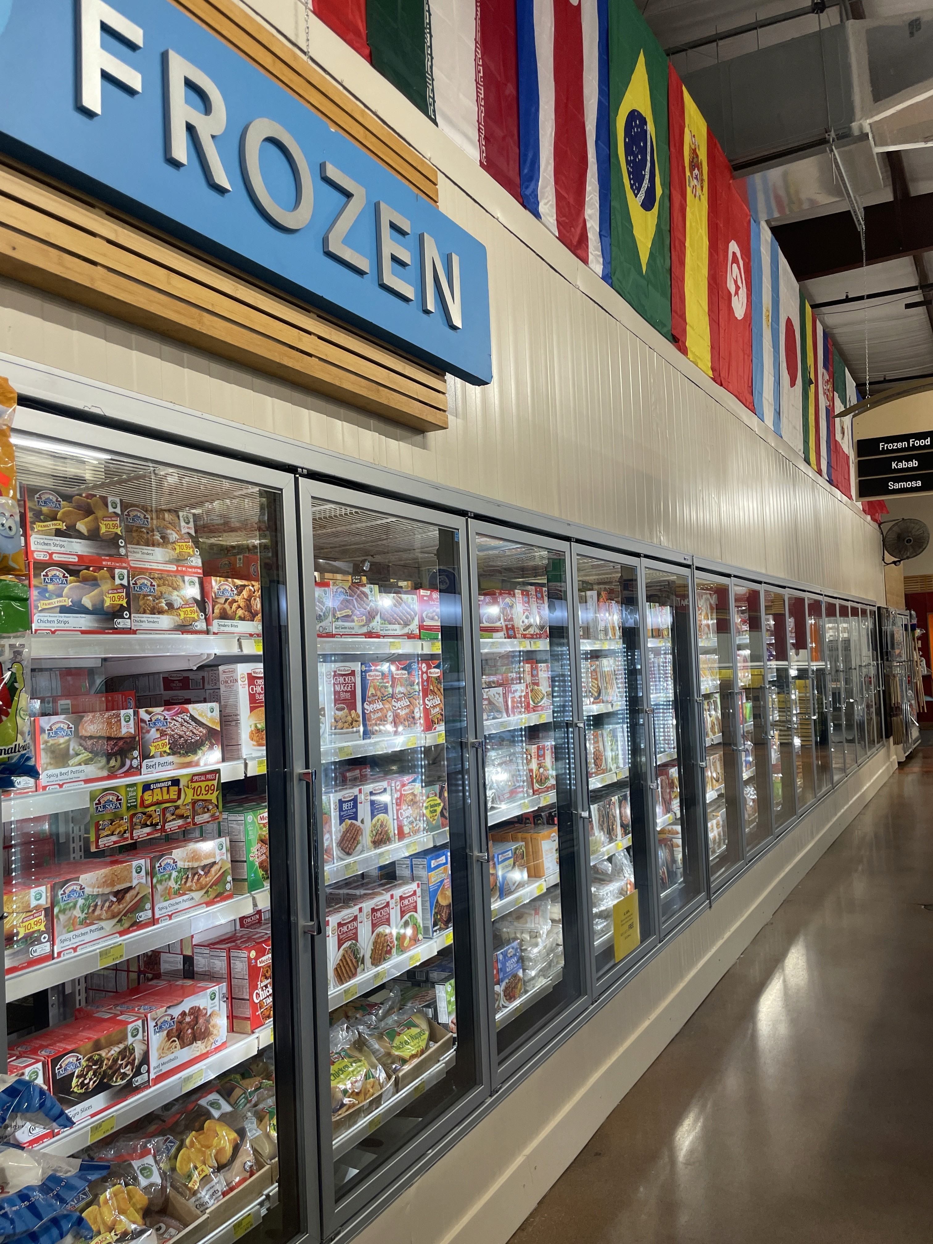 Frozen food aisle at International Food Market Orlando, offering a wide variety of frozen products.