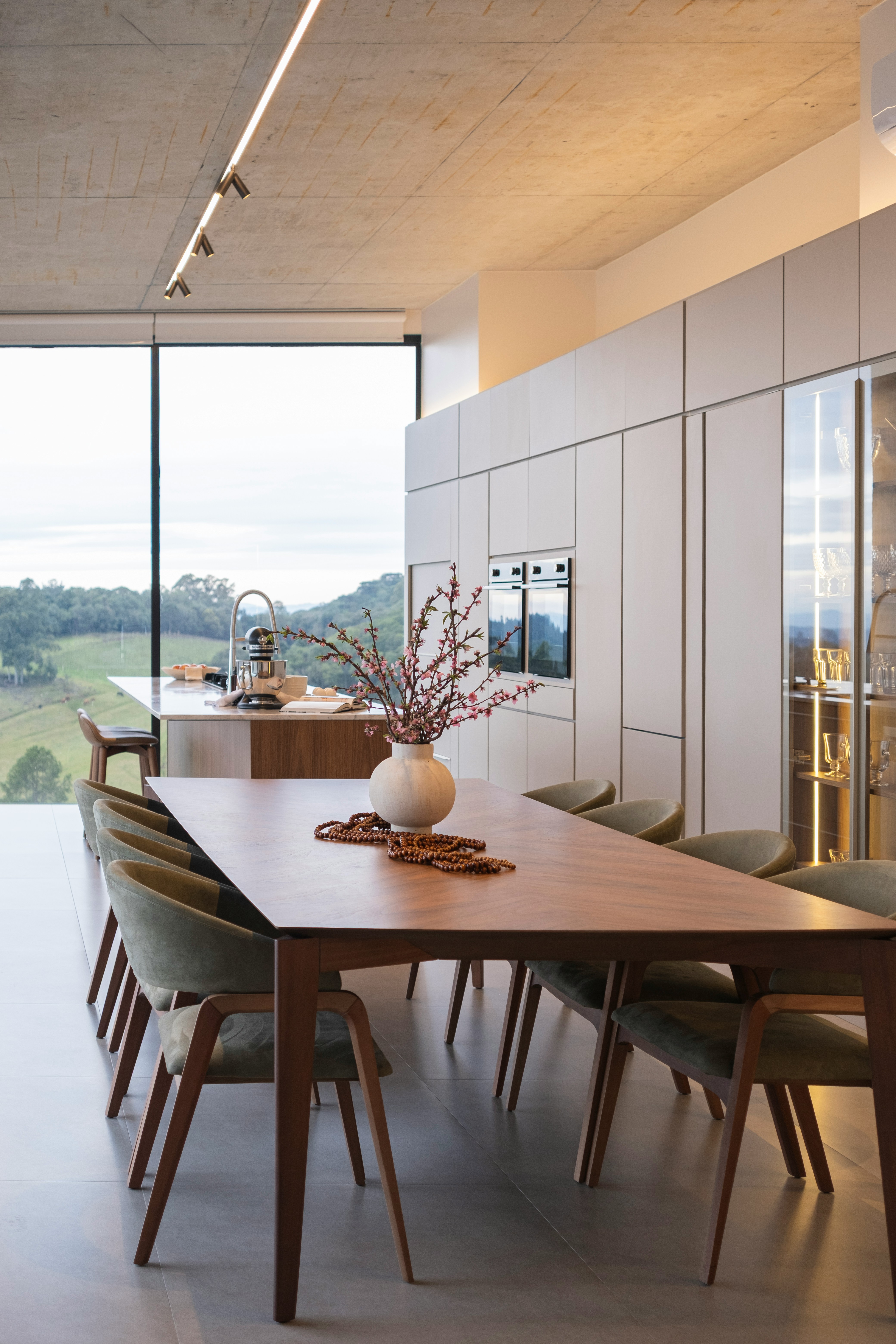 Modern dining room with large window and scenic view.