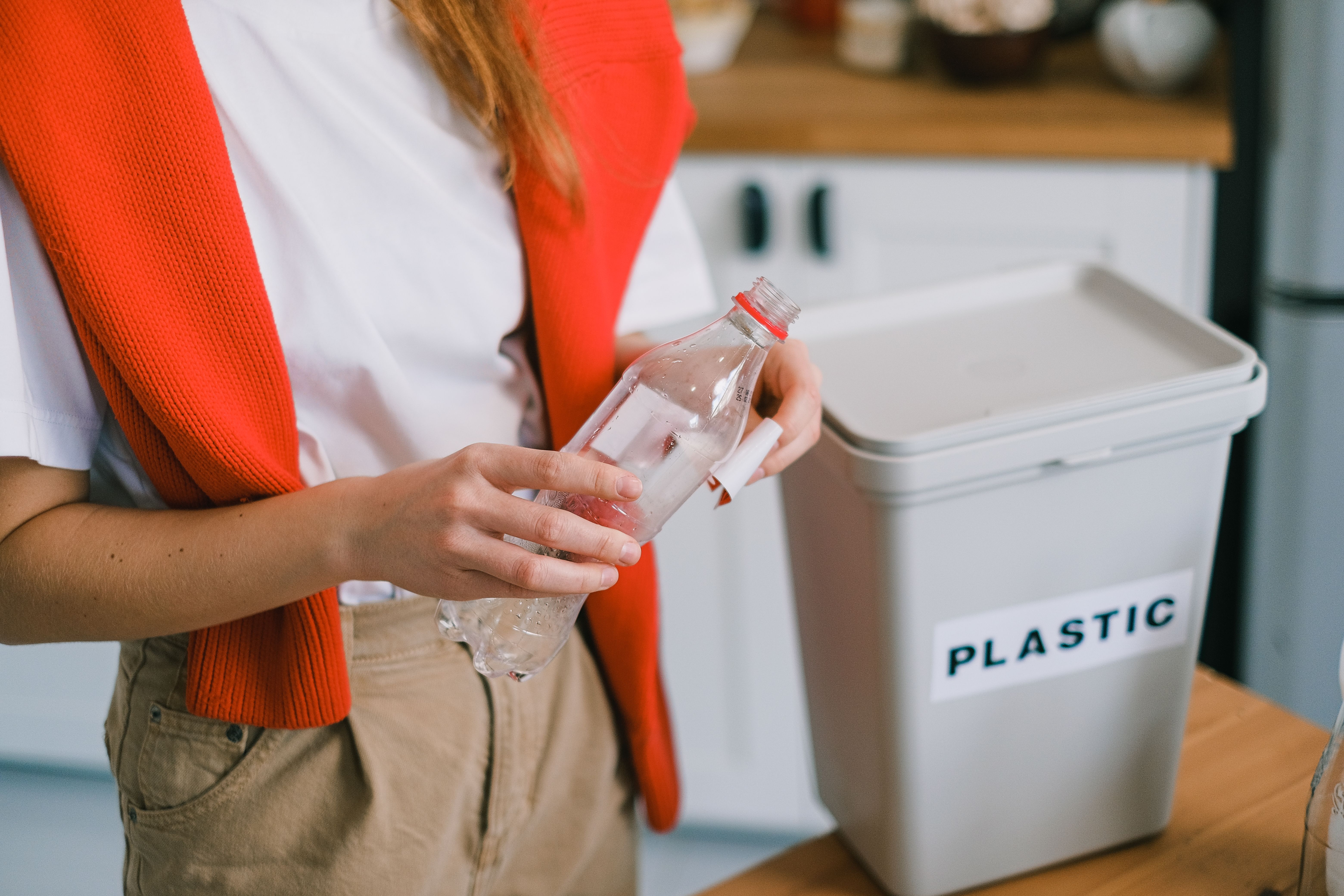 Women sorting recycling at home, deciding what they can and can't recycle.