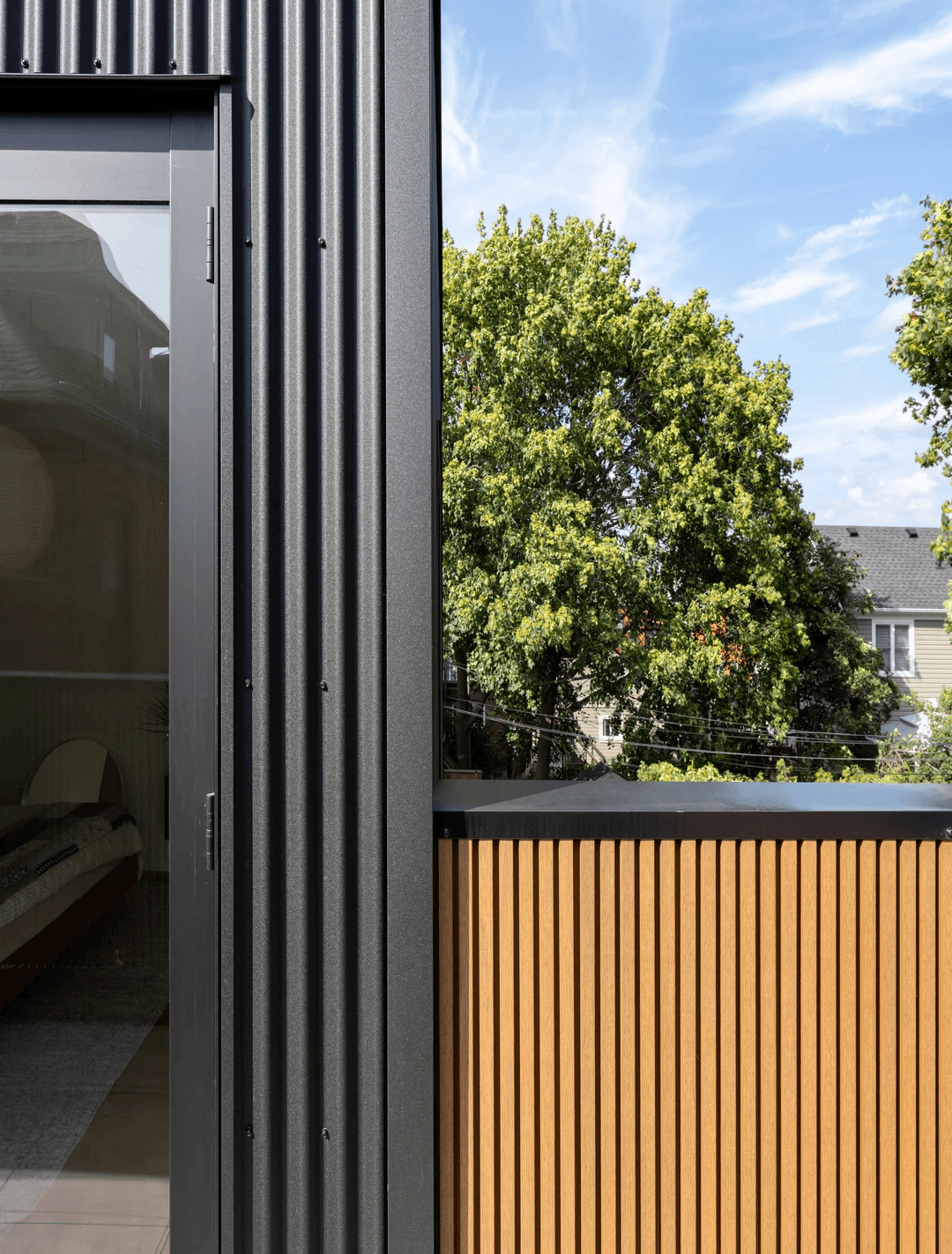 Custom Windsor Pinnacle Series wood-clad windows installed on a modern dark-clad century home addition in Hamilton