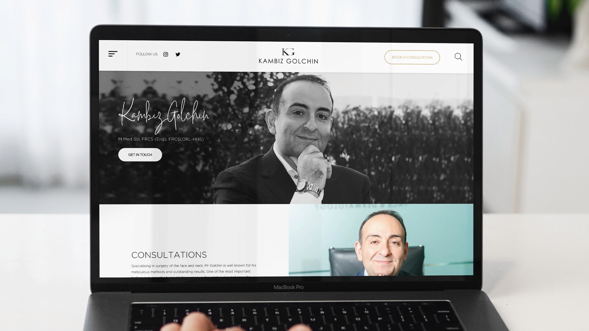Laptop showing the website of Kambiz Golein. Features photos of Kambiz Golein and options for consultations.