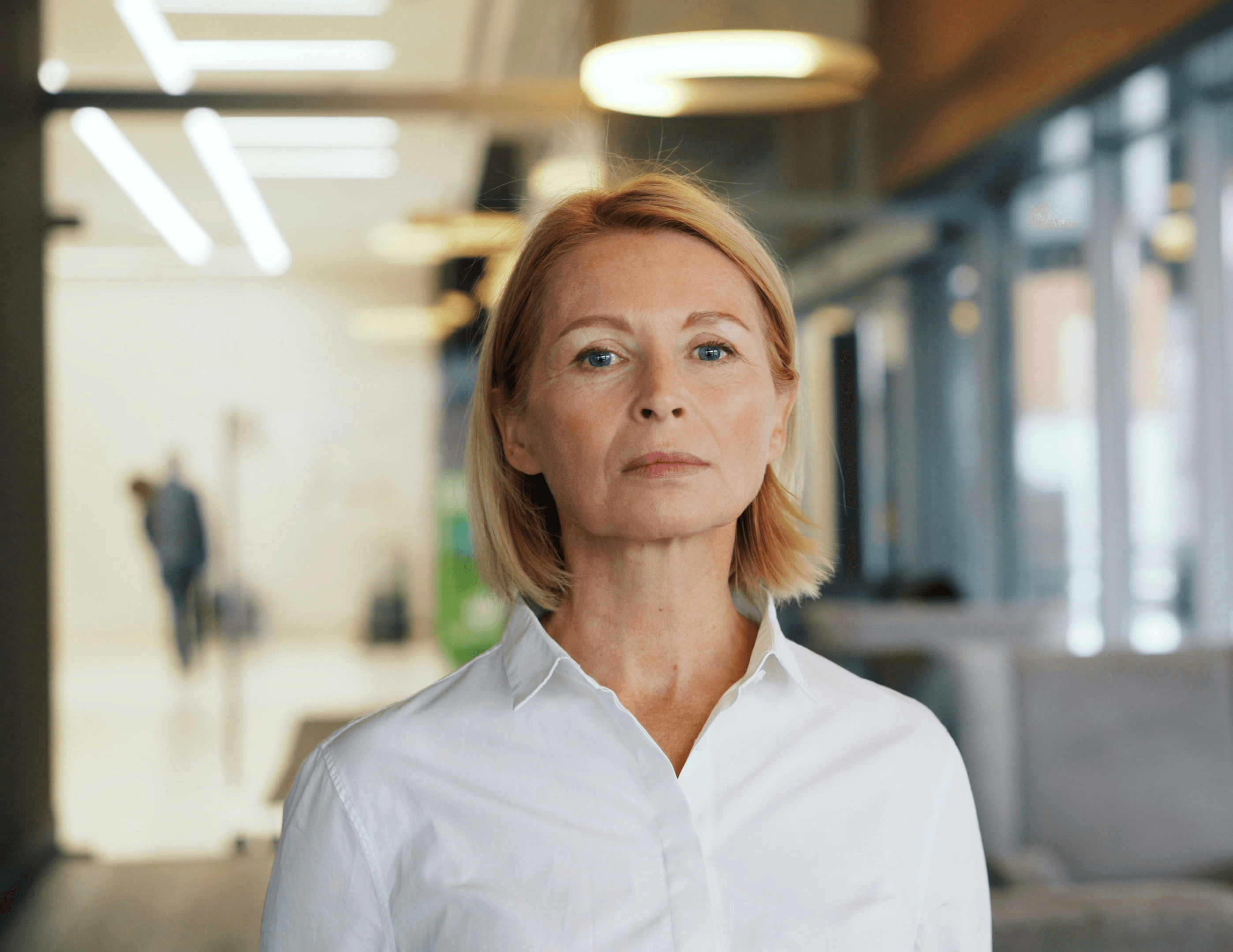 a woman standing in front of a couch in a room