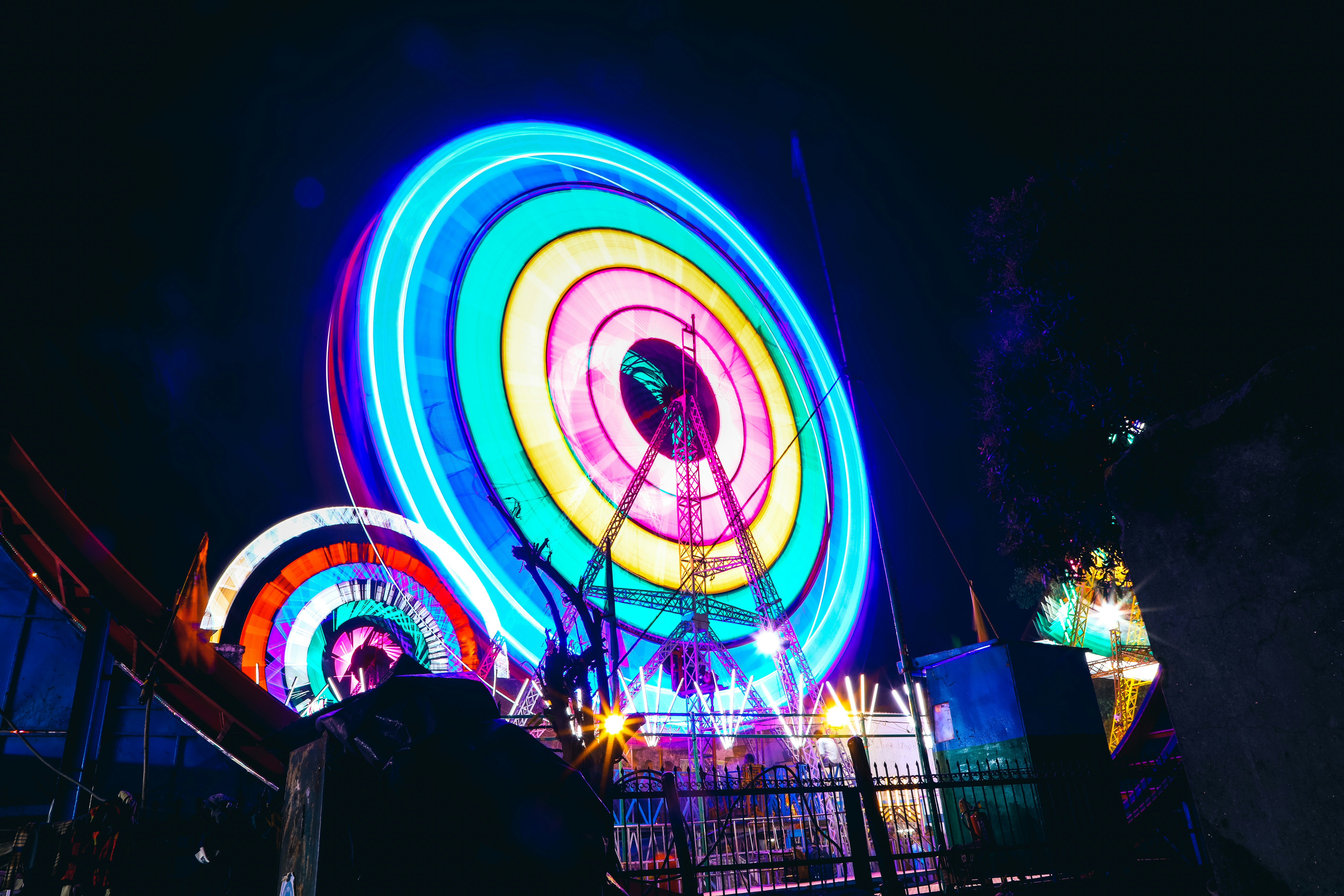 A colorful ferris wheel lit up at night