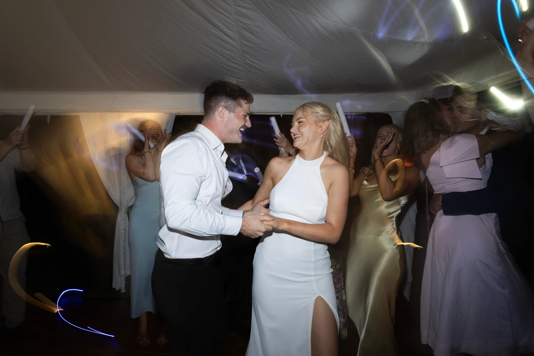 Bride and groom dancing amongst guests