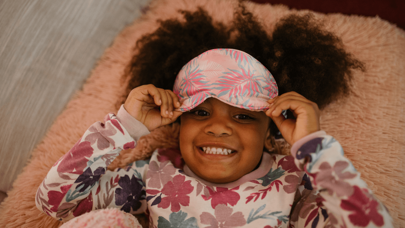 Child with sleepmask ready for bed.