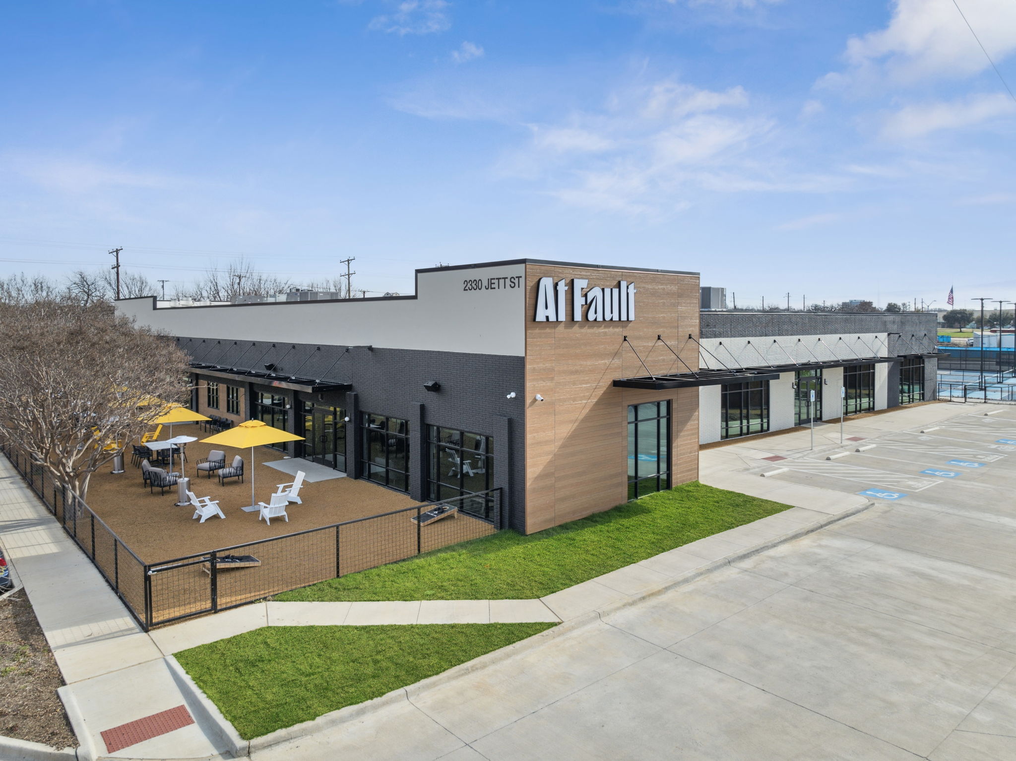 Exterior front-lit At Fault signage providing highway visibility at 2330 Jett Street in Dallas, Texas.