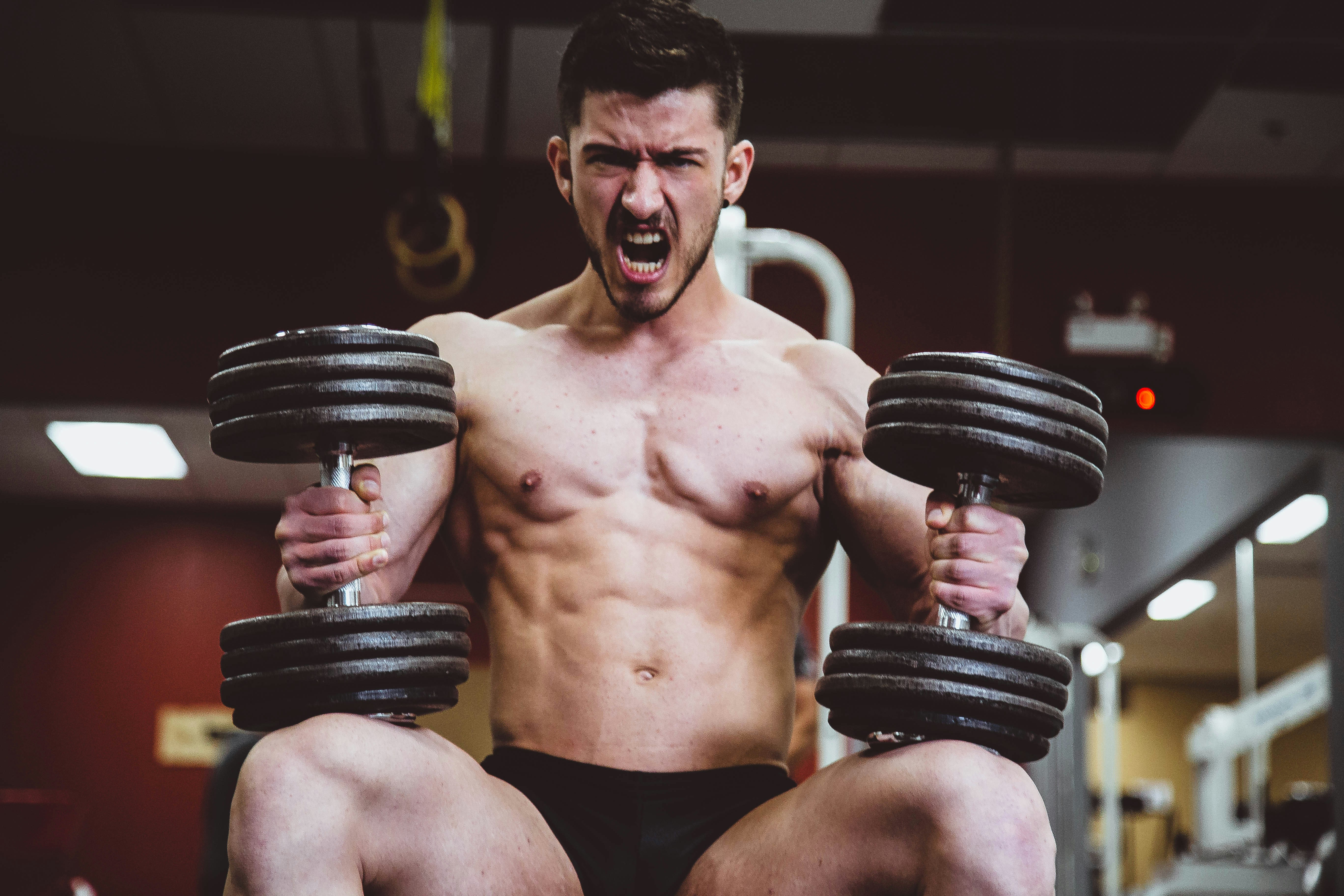 A Man Getting Ready To Dumbbell Shoulder Press