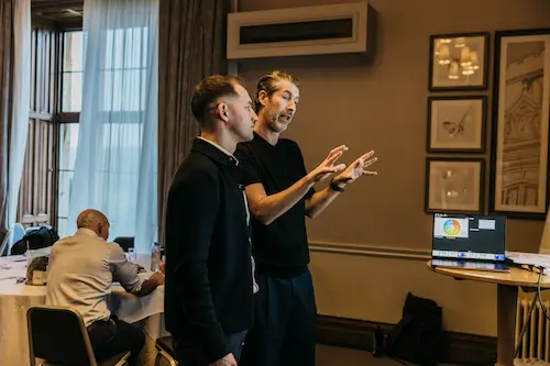 People playing a game with remote controllers in an office.