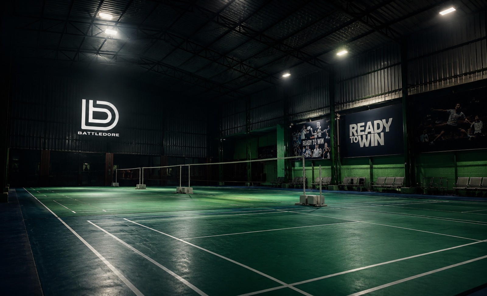 Outdoor basketball court under floodlights at night