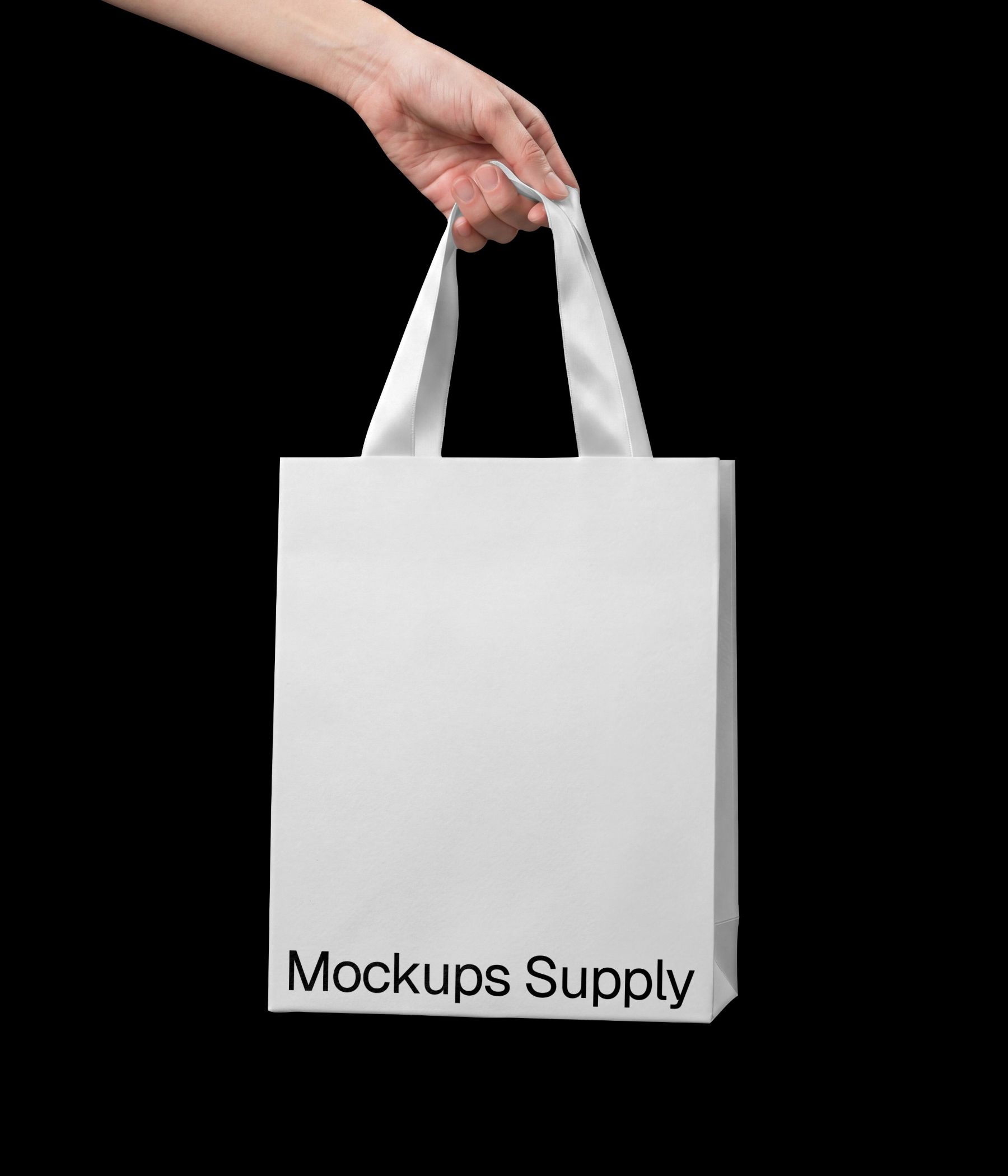 Hand holding paper boutique bag mockup with ribbon handle download PSD on Mockups Supply