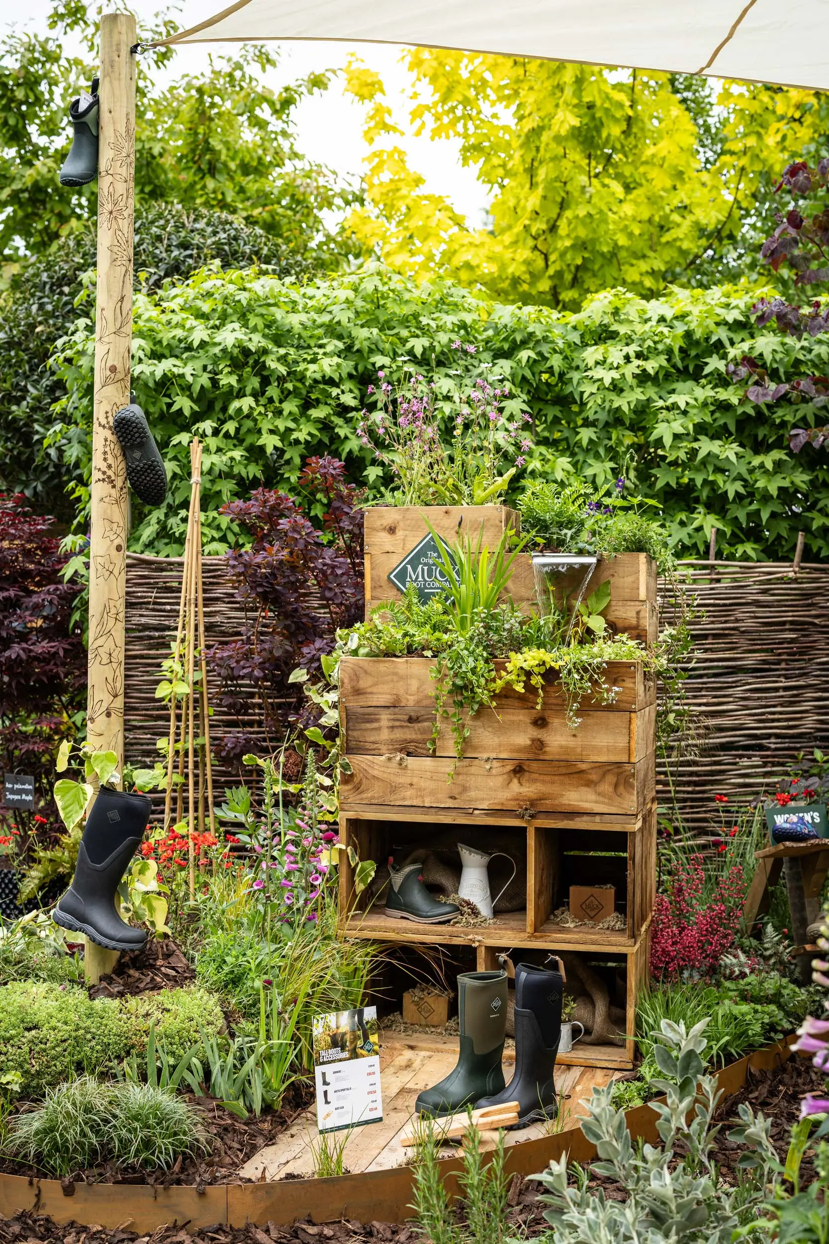 Lush green garden with wooden structures and plants, creating a serene and tranquil atmosphere.