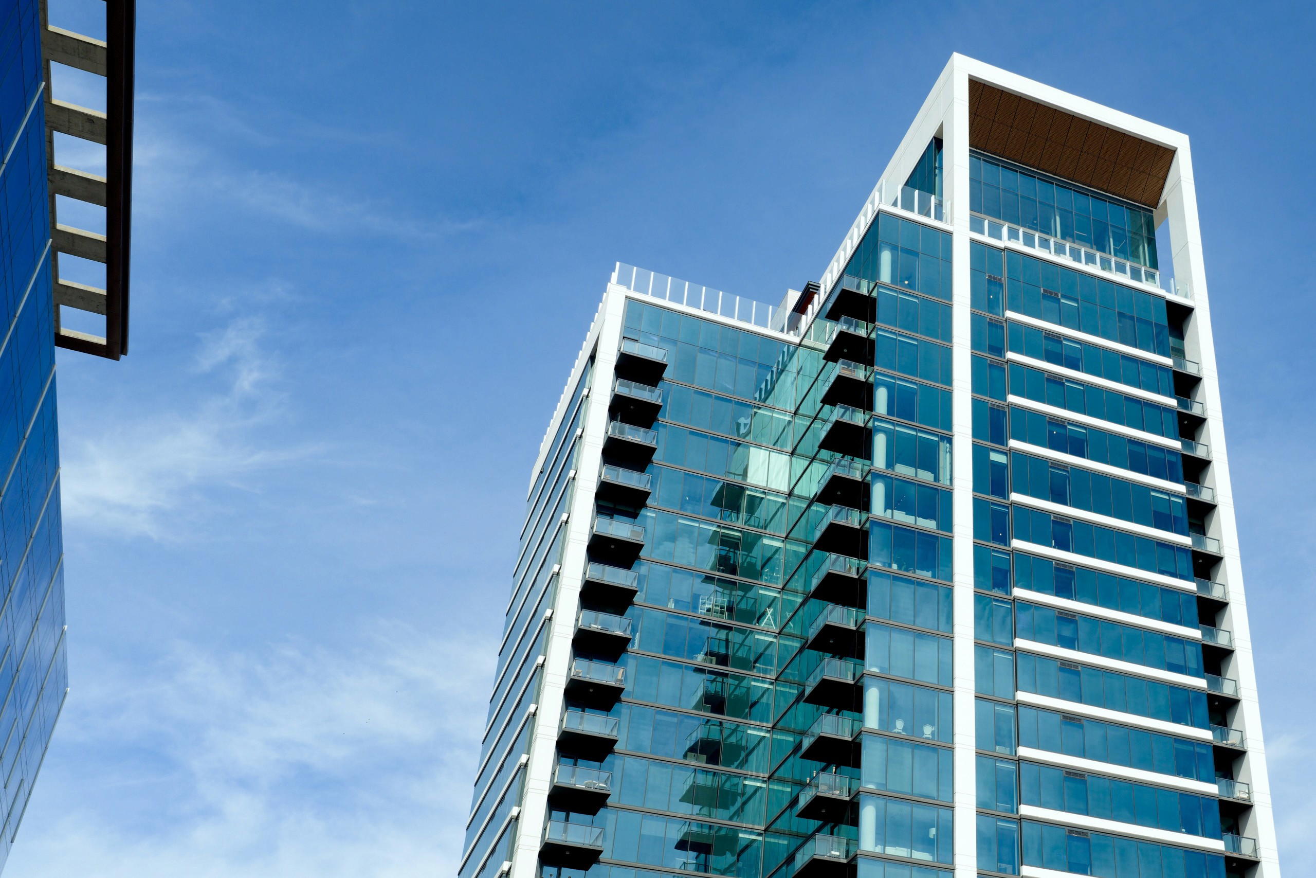 Modern glass building against blue sky.
