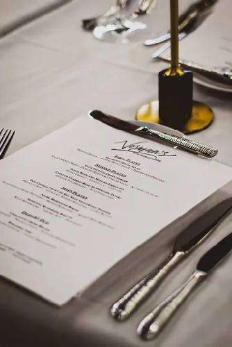 Normans orlando Kitchenmenu placed alongside silverware on a dining table