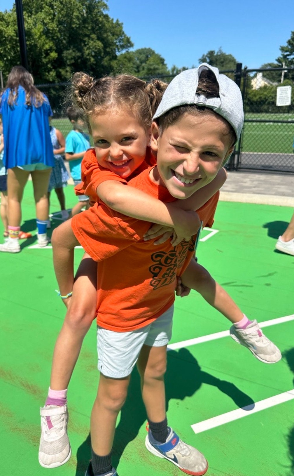 A group of students smiling in a hallway