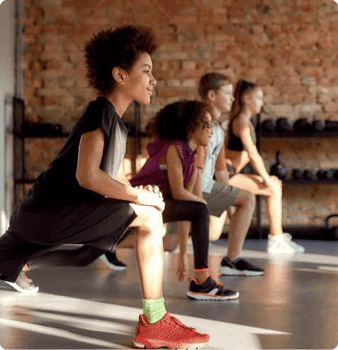 Students participating in structured physical education activities focused on fitness, coordination and teamwork