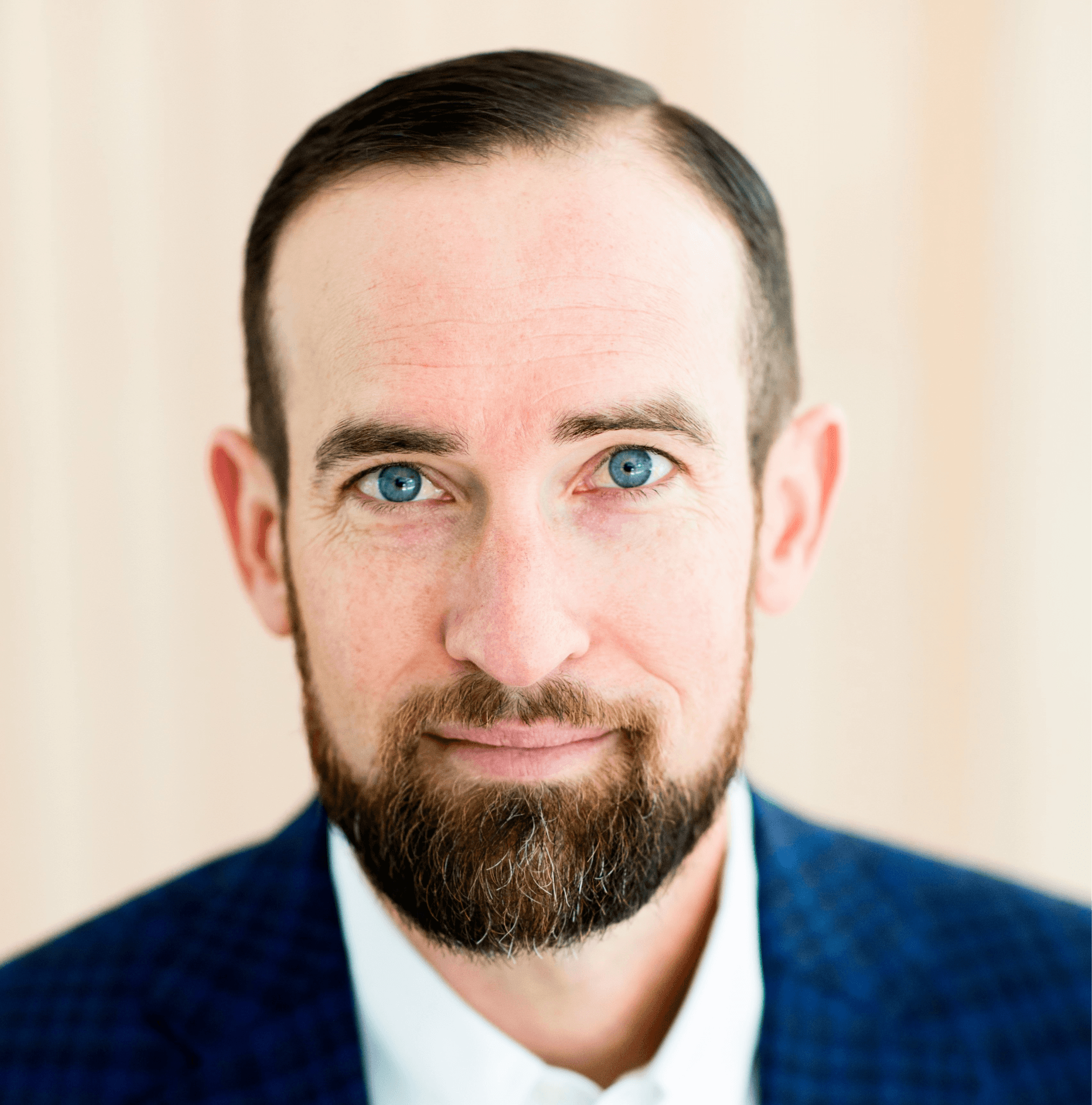 Close-up professional portrait of Chris Seegers wearing a blue suit jacket.