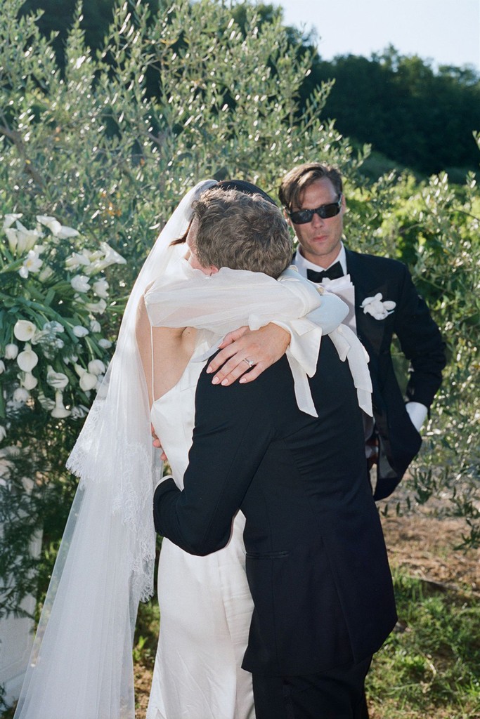 Bride and groom embracing after the ceremony in an olive grove setting