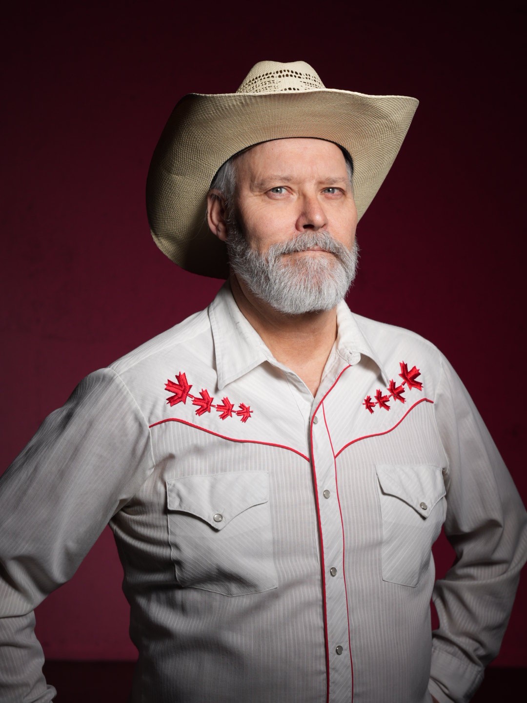 A close up of Mr. Roland, an agricultural worker. Wearing a white dress shirt with red maple leaves across his chest for Canada day.