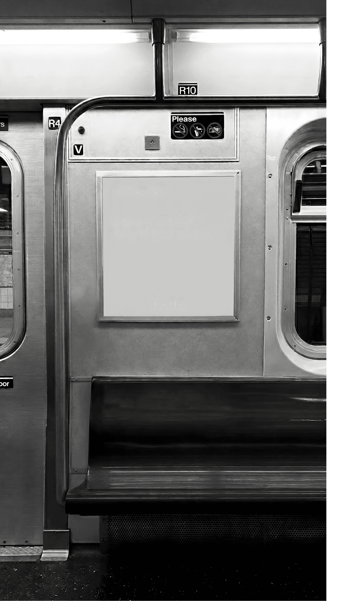 Black and white photo of a blank whiteboard mounted on a wall in an empty room