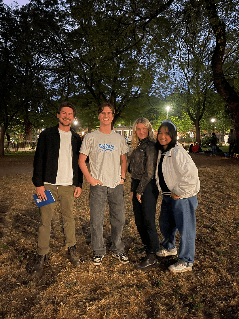 Four people at a park smiling